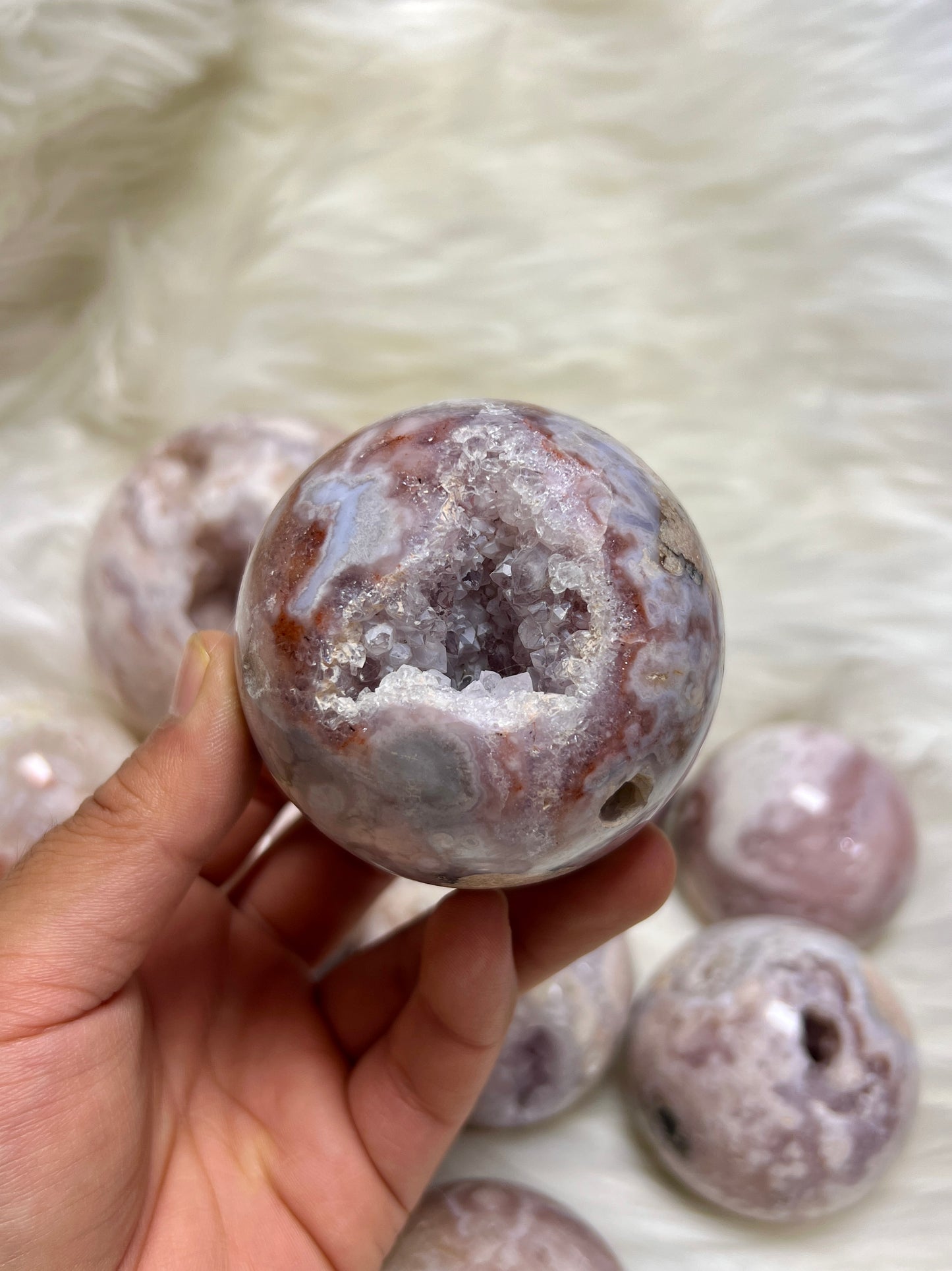 Pink amethyst with flower agate sphere